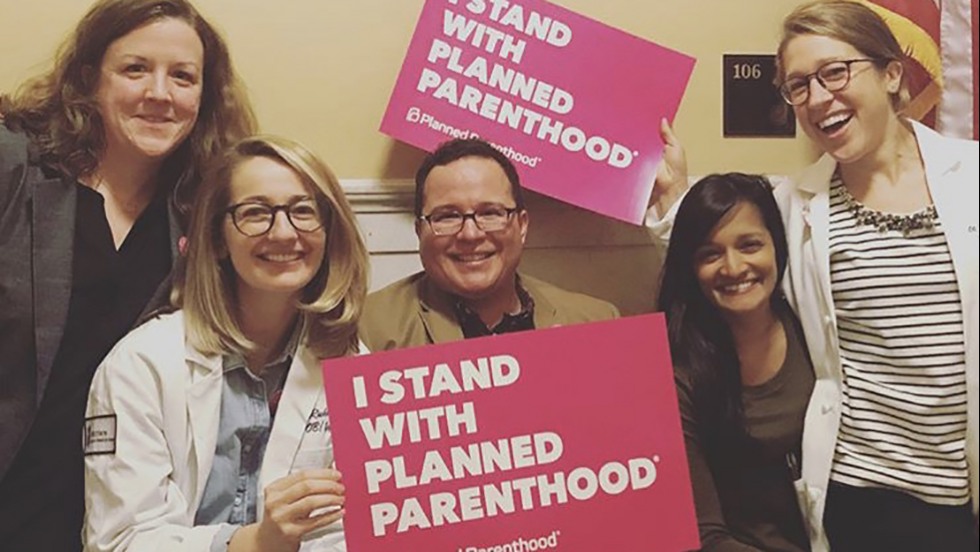 people holding planned parenthood signs