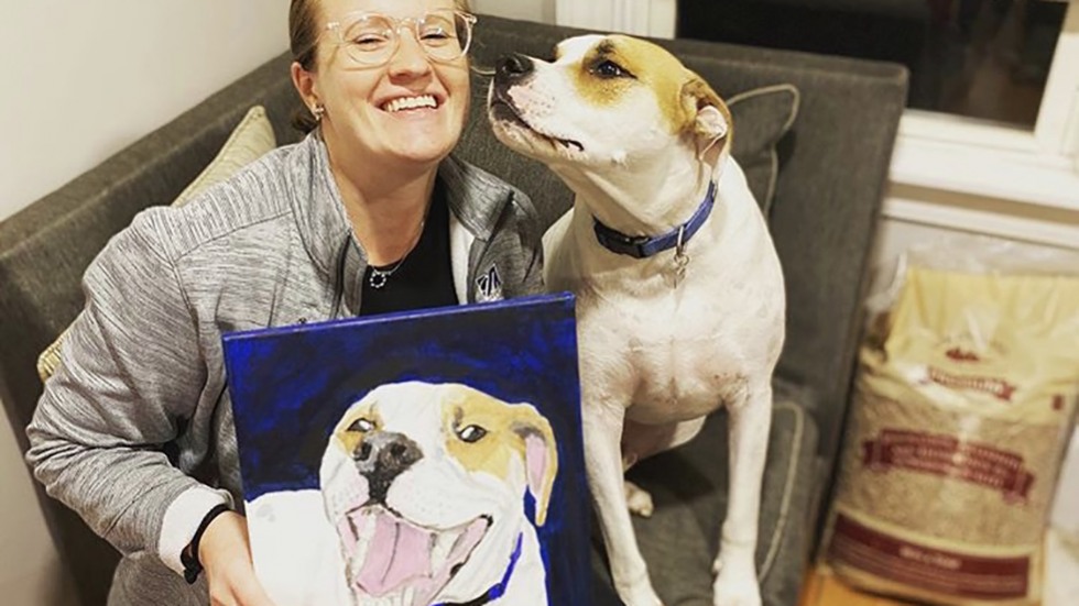 person with dog and painting of dog
