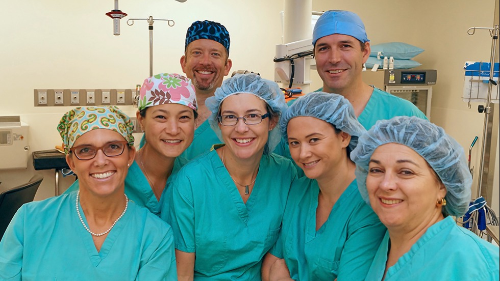 people in hospital scrubs posing for a photo