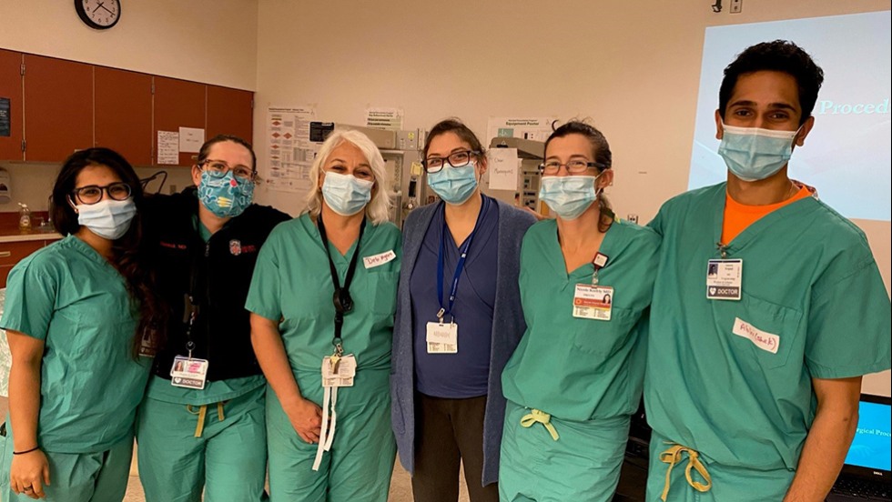 several people in hospital scrubs posing for a photo